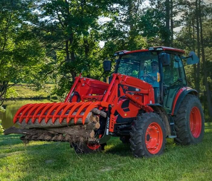 Routine Yard Maintenance with Gas-Powered Mower Person mowing green grass with a heavy-duty riding mower.